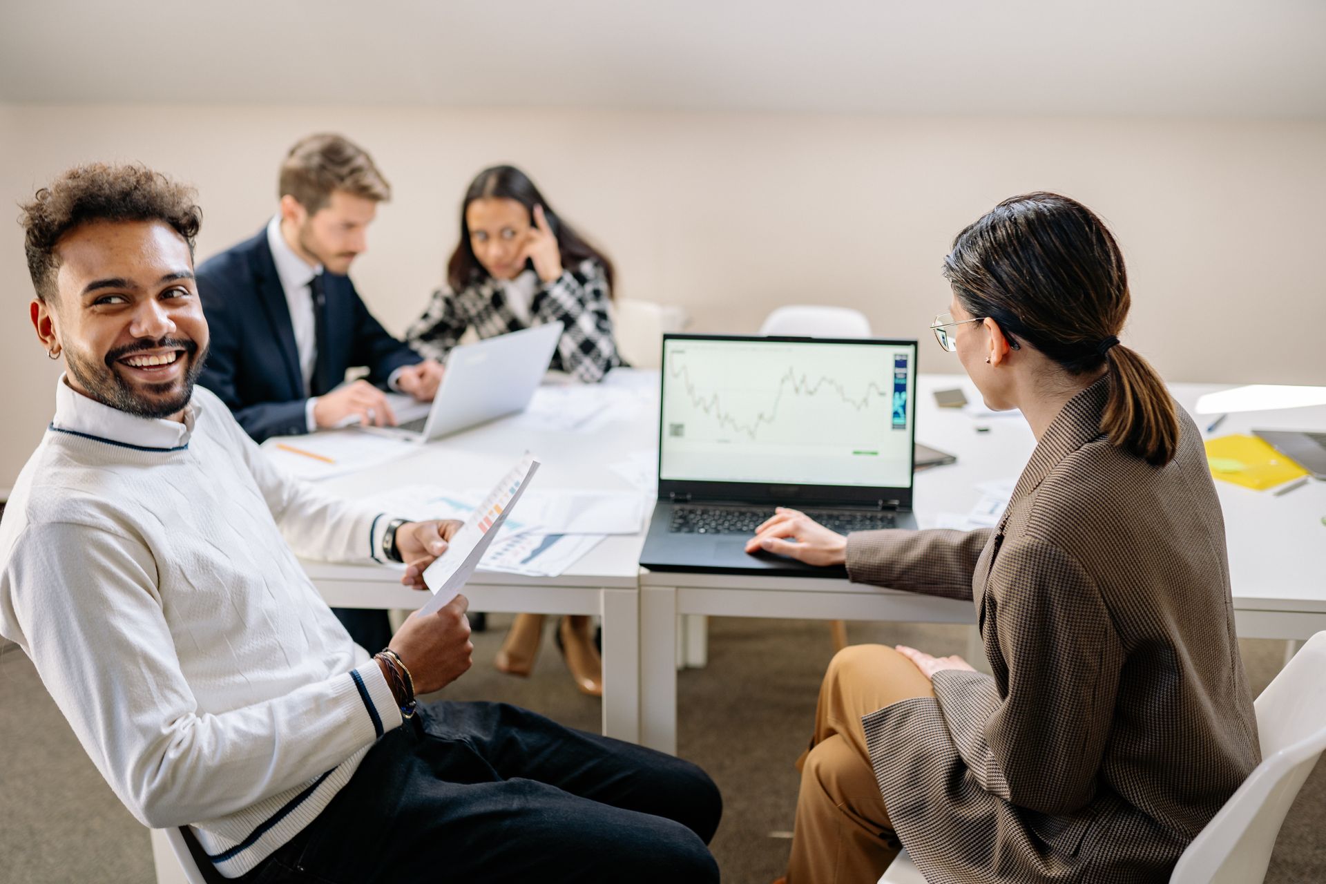 A diverse team collaborating around a table in a modern office